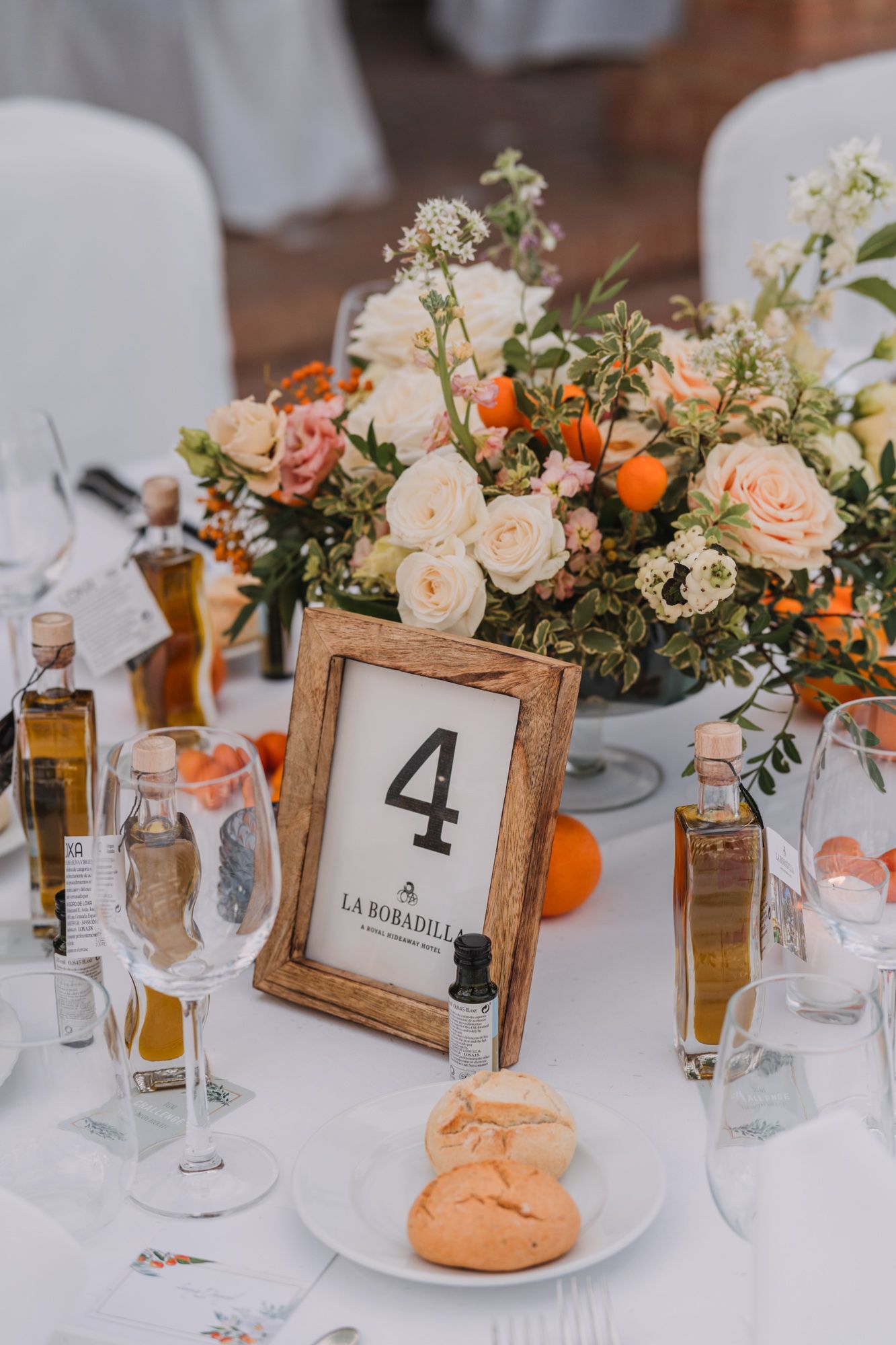 Elegant table setting with floral centerpiece, table number 4, and champagne glasses.