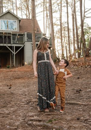 A charming woodland scene with a rustic treehouse in the background.