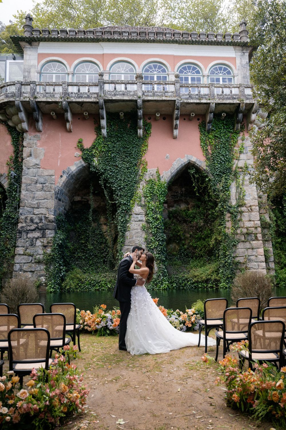 Elegant wedding ceremony location with vintage architecture and floral decorations.