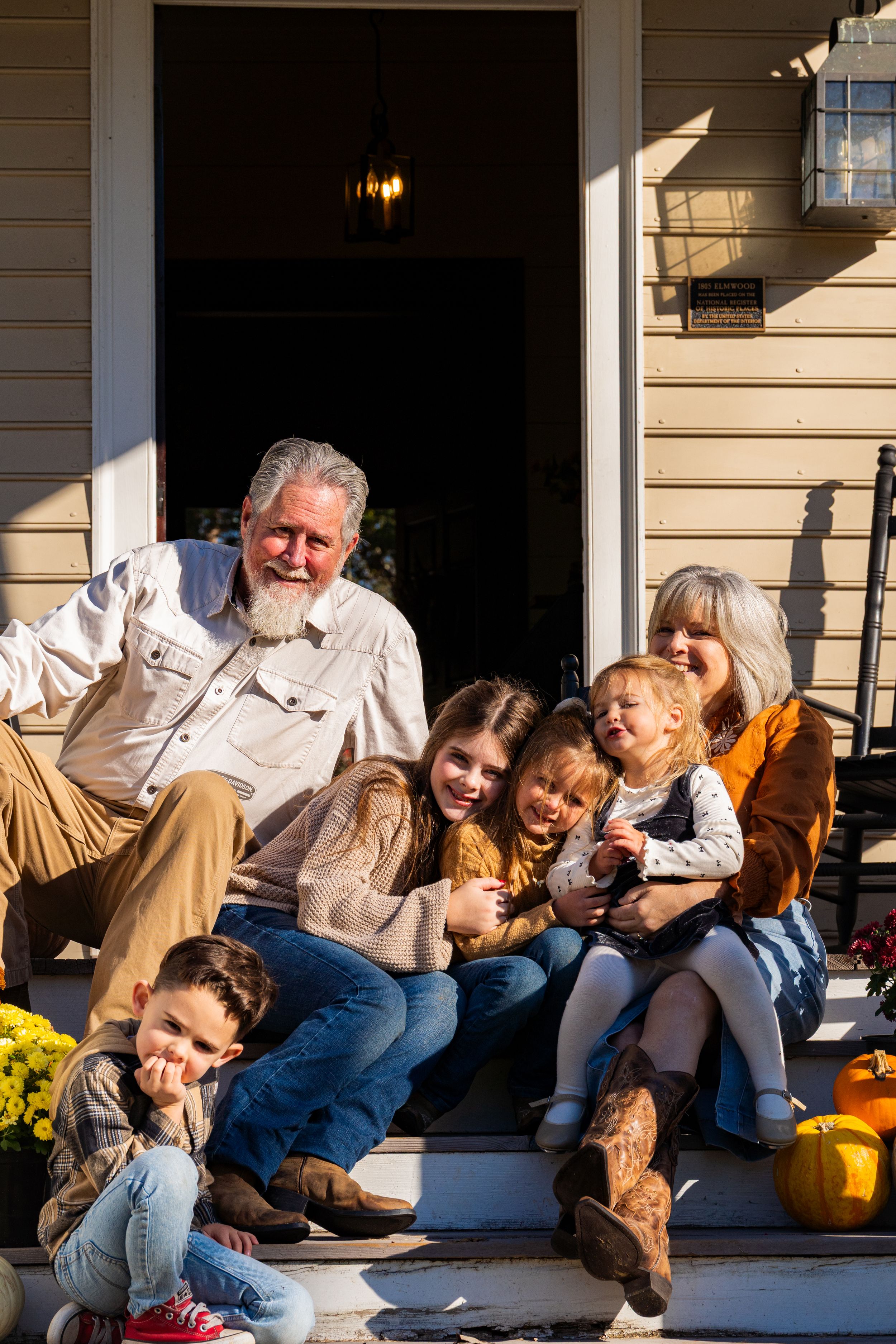 A series of candid photos showing a playful family moment together on their front porch steps.