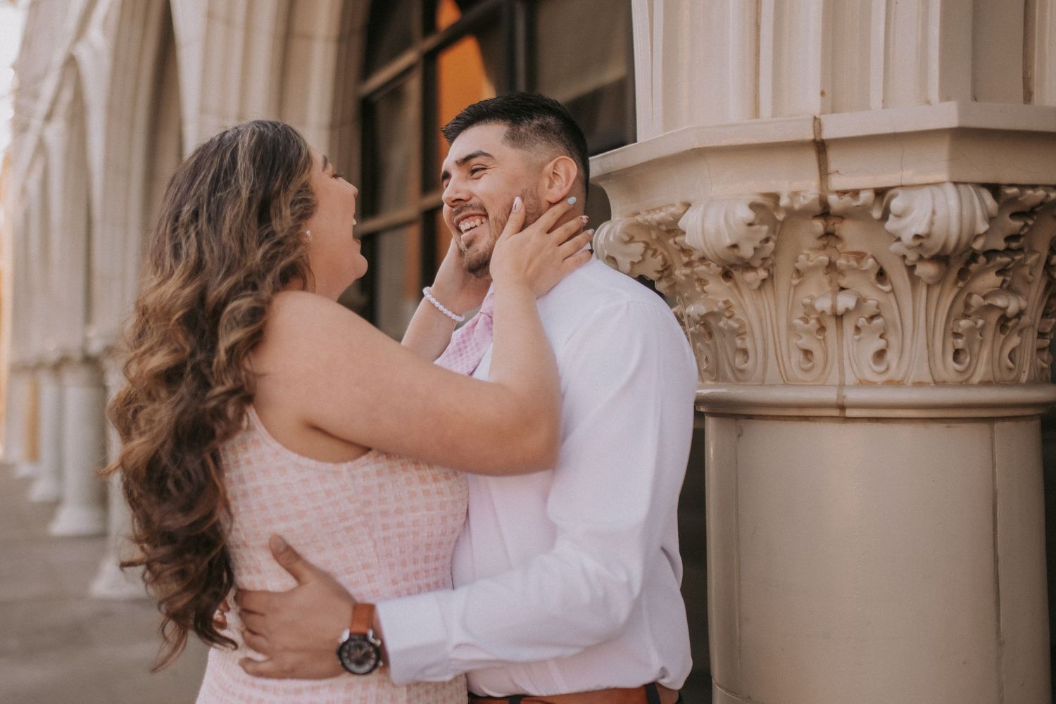 A couple shares an intimate moment while embracing against an architectural column in downtown albuquerque. What to wear for couples photos.