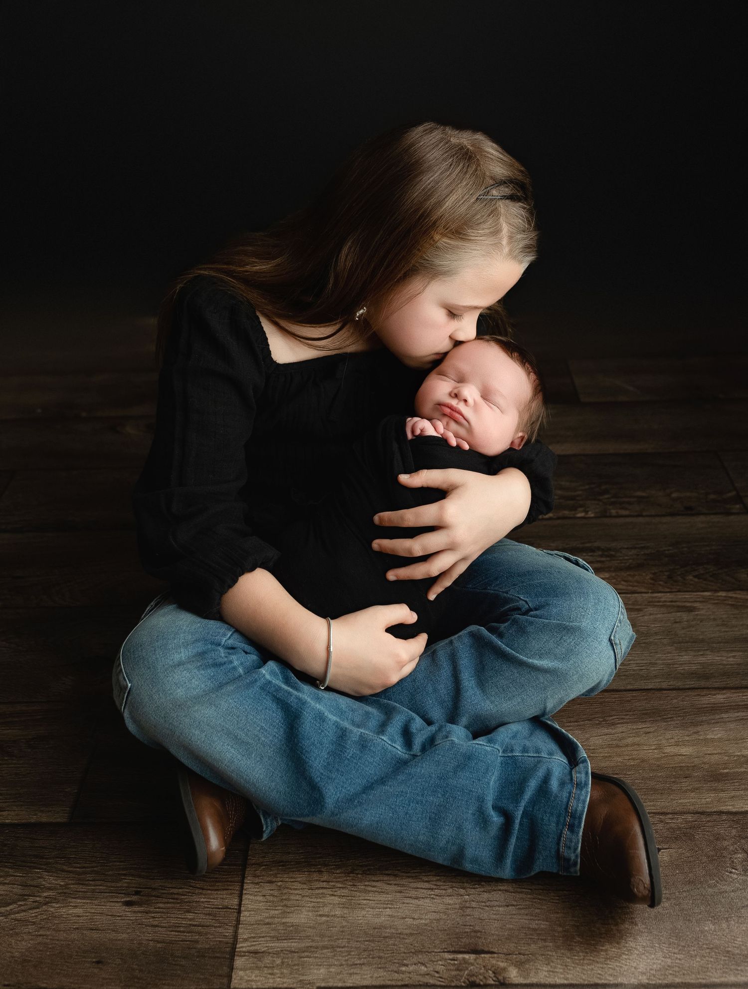 Big sister sitting and holding newborn brother. Greenville SC newborn photographer, Easley, SC newborn photographer, Upstate newborn photogr
