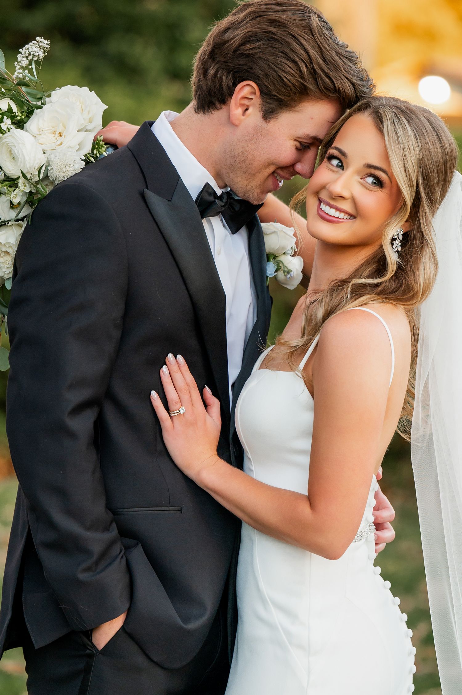 Romantic wedding portraits showing joyful moments between newlyweds in classic attire.