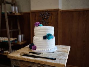 A white wedding cake decorated with purple and blue flowers.

Indiana Weddings
Illinois Weddings
Michigan Weddings
Weddings