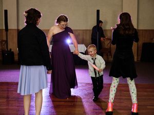 People dance in a ballroom during a wedding.