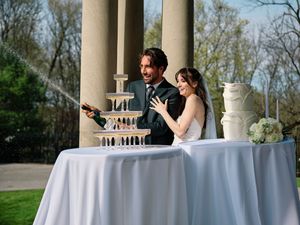 A couple shares a fun moment popping champagne bottle at their wedding.

Indiana Weddings
Illinois Weddings
Michigan Weddings
Weddings