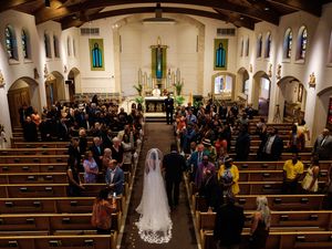 Guests stand in pews while bride and groom walk down the aisle in Catholic ceremony.

Indiana Weddings
Illinois Weddings
Michigan Weddings