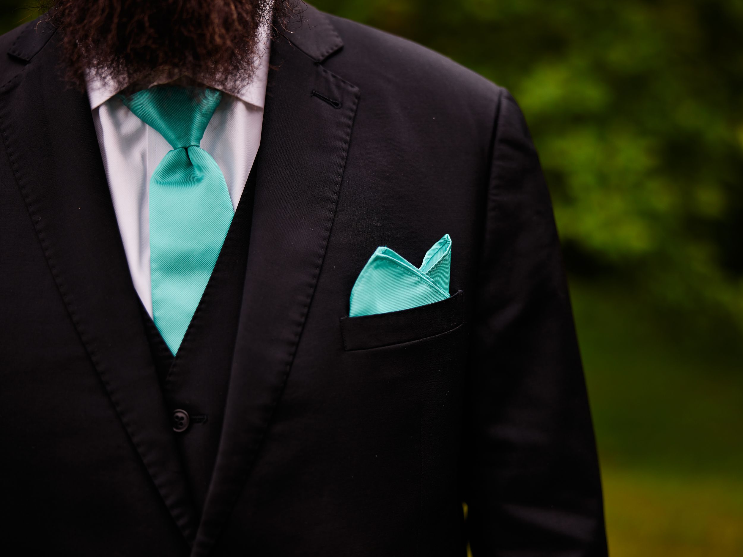 A black suit jacket paired with a turquoise tie and pocket squaree.
Indiana Weddings
Illinois Weddings
Michigan Weddings
Weddings