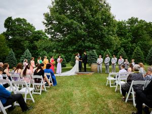 An outdoor wedding ceremony with white chairs and tall trees in the background.

Indiana Weddings
Illinois Weddings
Michigan Weddings