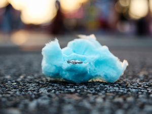 A silver ring sits nestled in a tuft of bright blue cotton candy on asphalt pavement.

Indiana Weddings
Illinois Weddings
Michigan Weddings