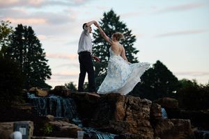 A couple stands atop a waterfall at sunset, with the bride's dress flowing.

Indiana Weddings
Illinois Weddings
Michigan Weddings