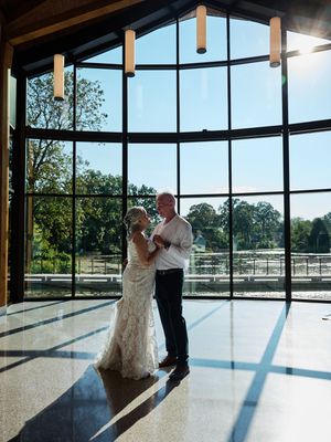 A couple shares their first dance in a modern venue with floor-to-ceiling windows.

Indiana Weddings
Illinois Weddings
Michigan Weddings