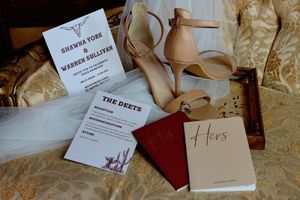 Elegant table settings with name cards and menus arranged on cream colored linens at a formal event.