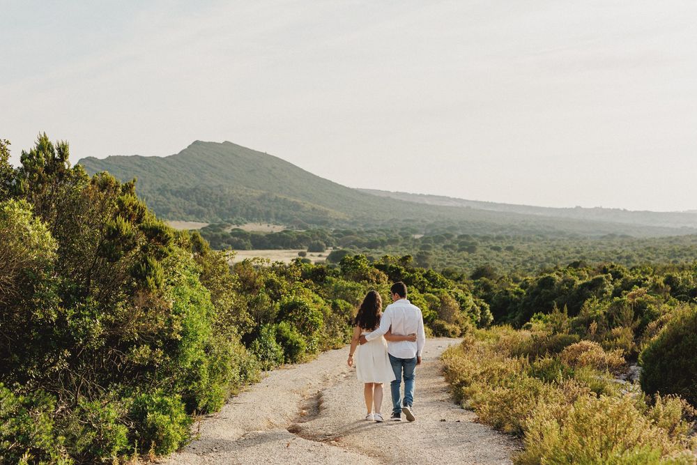 Couple walking together in Arrábida mountains during pre-wedding photos in Setúbal with scenic natural background