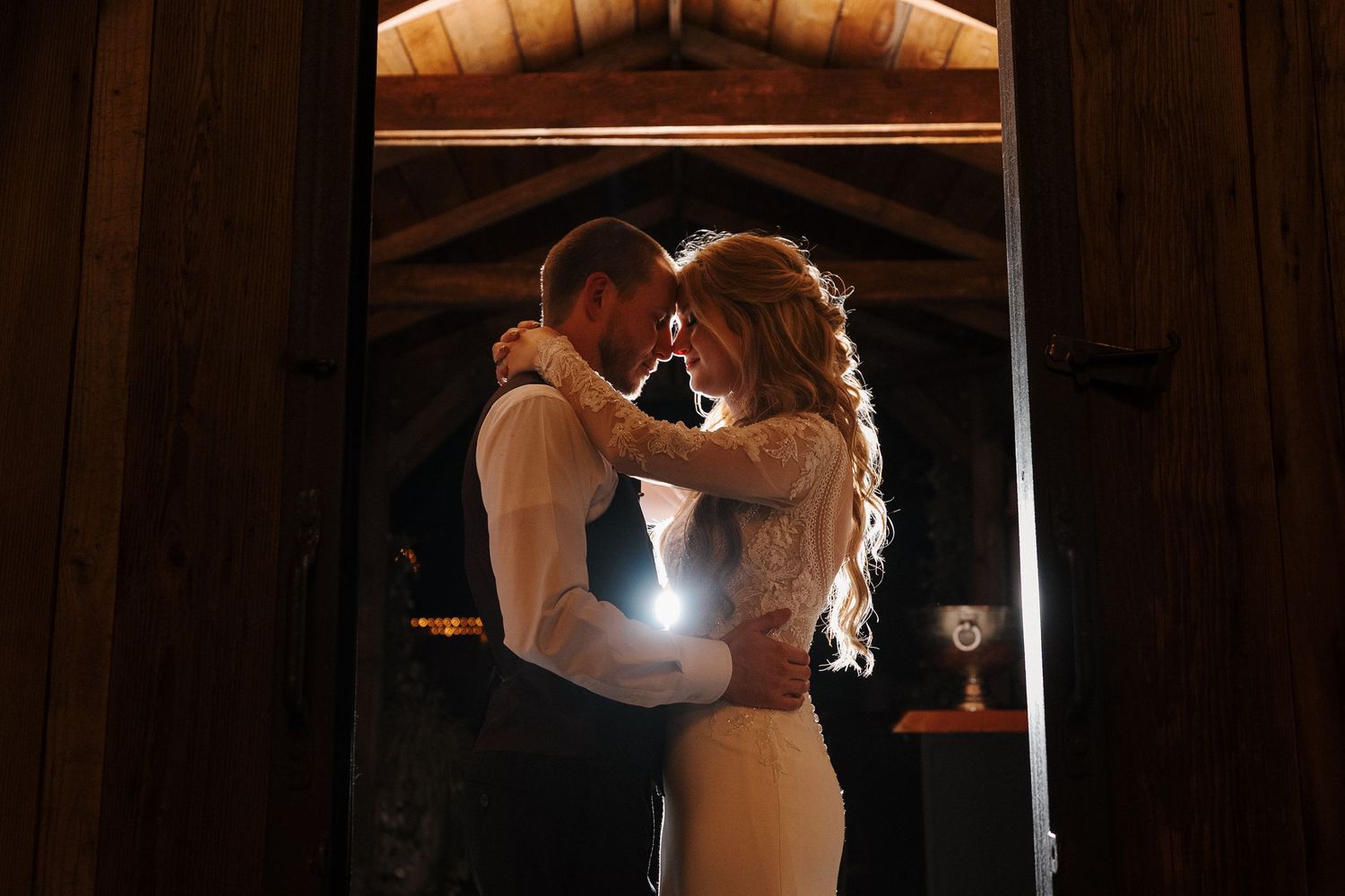 Elegant wedding reception venue with flowing champagne drapes and warm lighting creating a romantic ambiance.