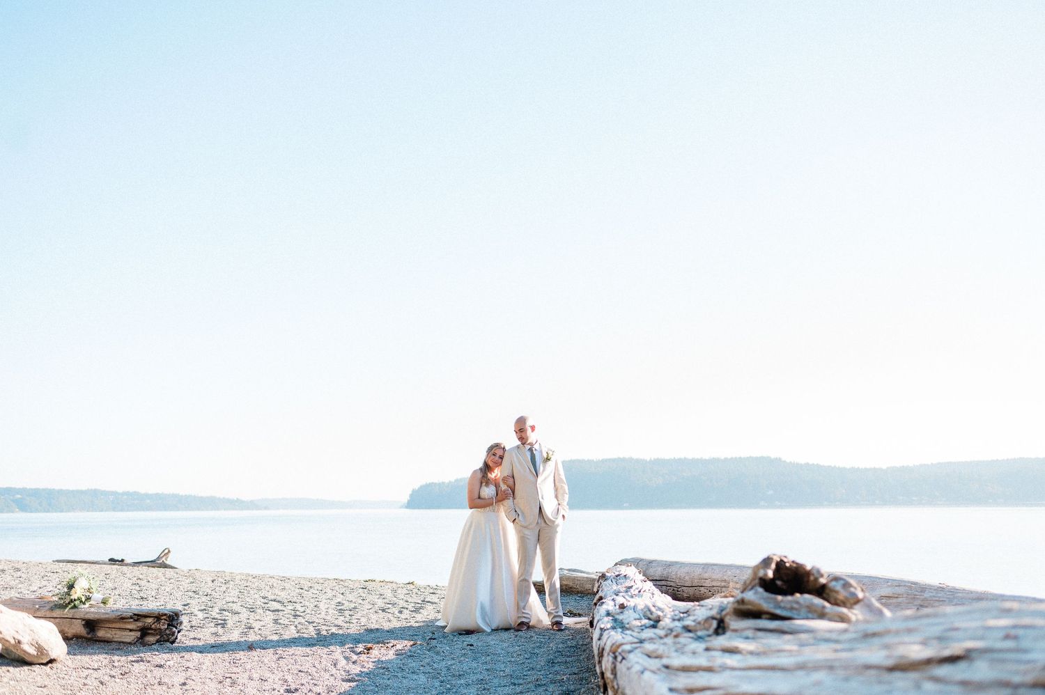 couple sits on rocks overlooking lake in Washington