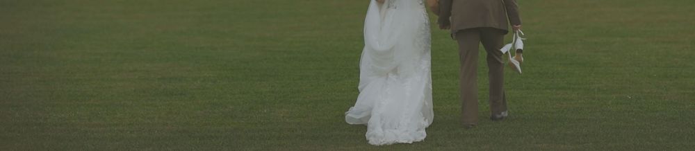 Outdoor scene showing white objects arranged on grassy terrain against a natural background.