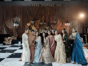 Models walk the runway in elegant period-inspired gowns during a historical fashion show presentation.