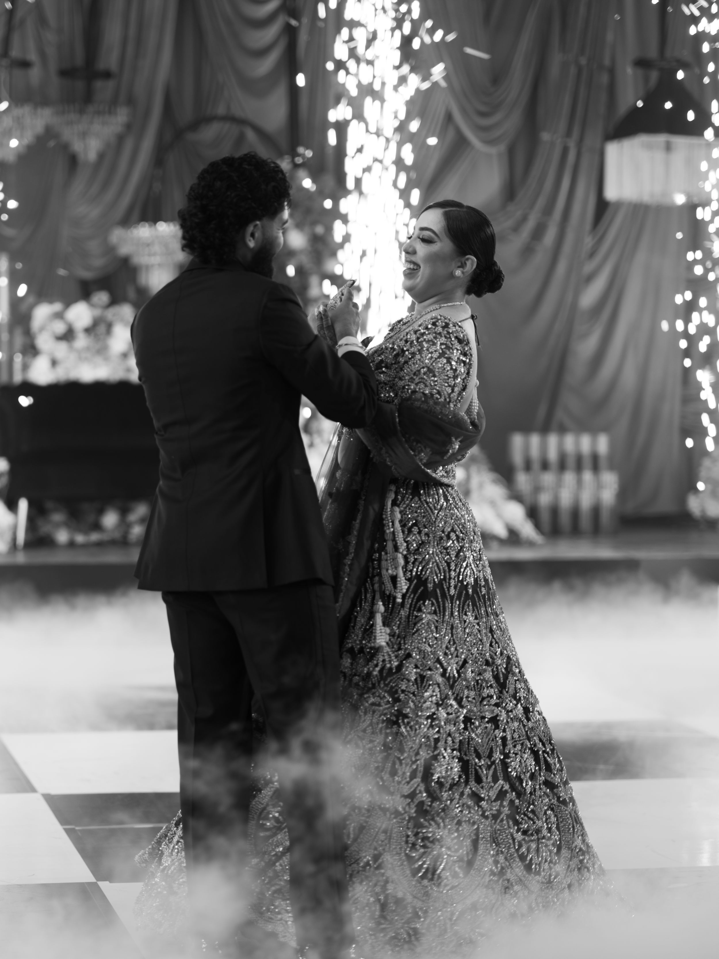 Ethereal black and white photo of a wedding dance with fog effects on the dance floor.