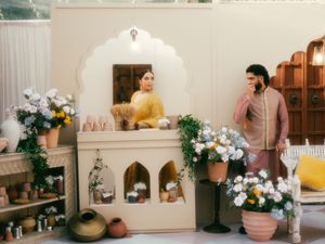 Traditional Indian home interior with arched mantle, floral decorations, and yellow accents.