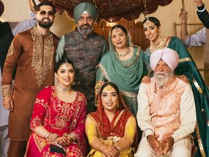 Wedding party gathering in colorful traditional Indian attire.