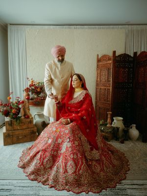 Wedding portraits featuring intricate red and gold traditional Indian bridal lehengas with floral decor.