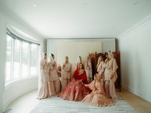 Wedding preparation room with multiple elegant dresses displayed in natural light.