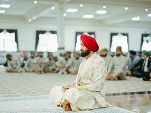 Traditional wedding ceremony setting with white decor and red accents.