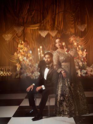 Dramatic evening photoshoot with moody lighting and ornate gold decor.