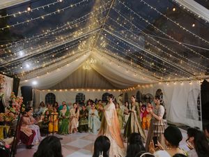 Wedding reception venue with twinkling string lights creating a magical ceiling canopy.