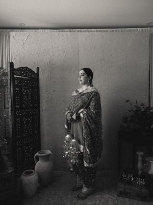 Black and white photo series showing a traditional pottery vase against a textured wall with dramatic lighting.