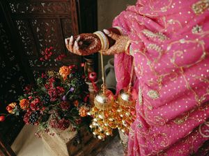 Pink floral wedding decor details with sparkling lights and vibrant orange flowers.