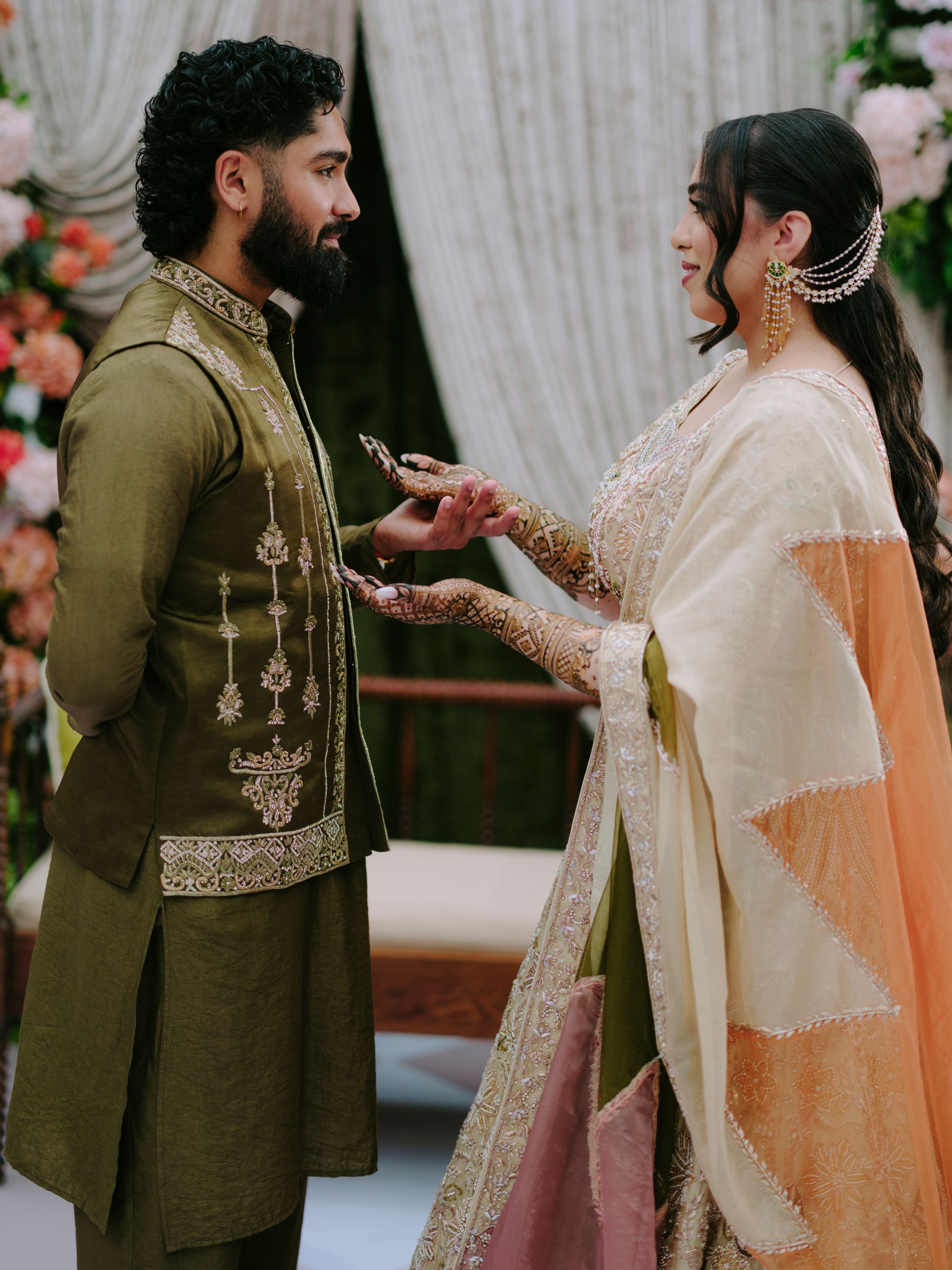 Traditional wedding celebration with guests in elegant ethnic attire gathered during a ceremonial moment.
