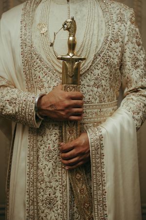 A series of detailed shots showing intricate white lace embroidery and embellishments on a traditional white dress.