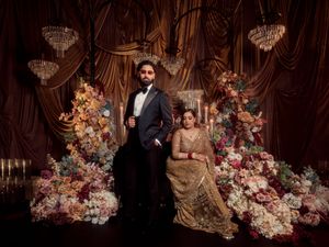 Romantic wedding setup with ornate floral decorations and crystal chandeliers creating an intimate atmosphere.