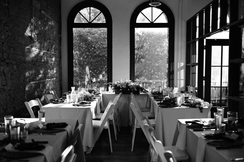 Sunlight streams through large windows in a modern living space with minimalist black and white interior design.