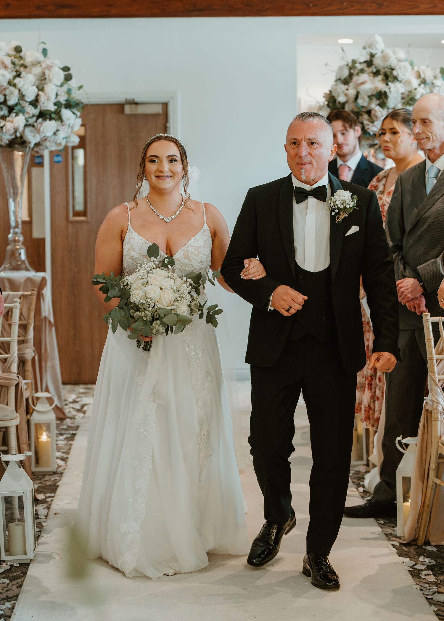 A series of wedding ceremony photos showing the bride walking down the church aisle with her escort.