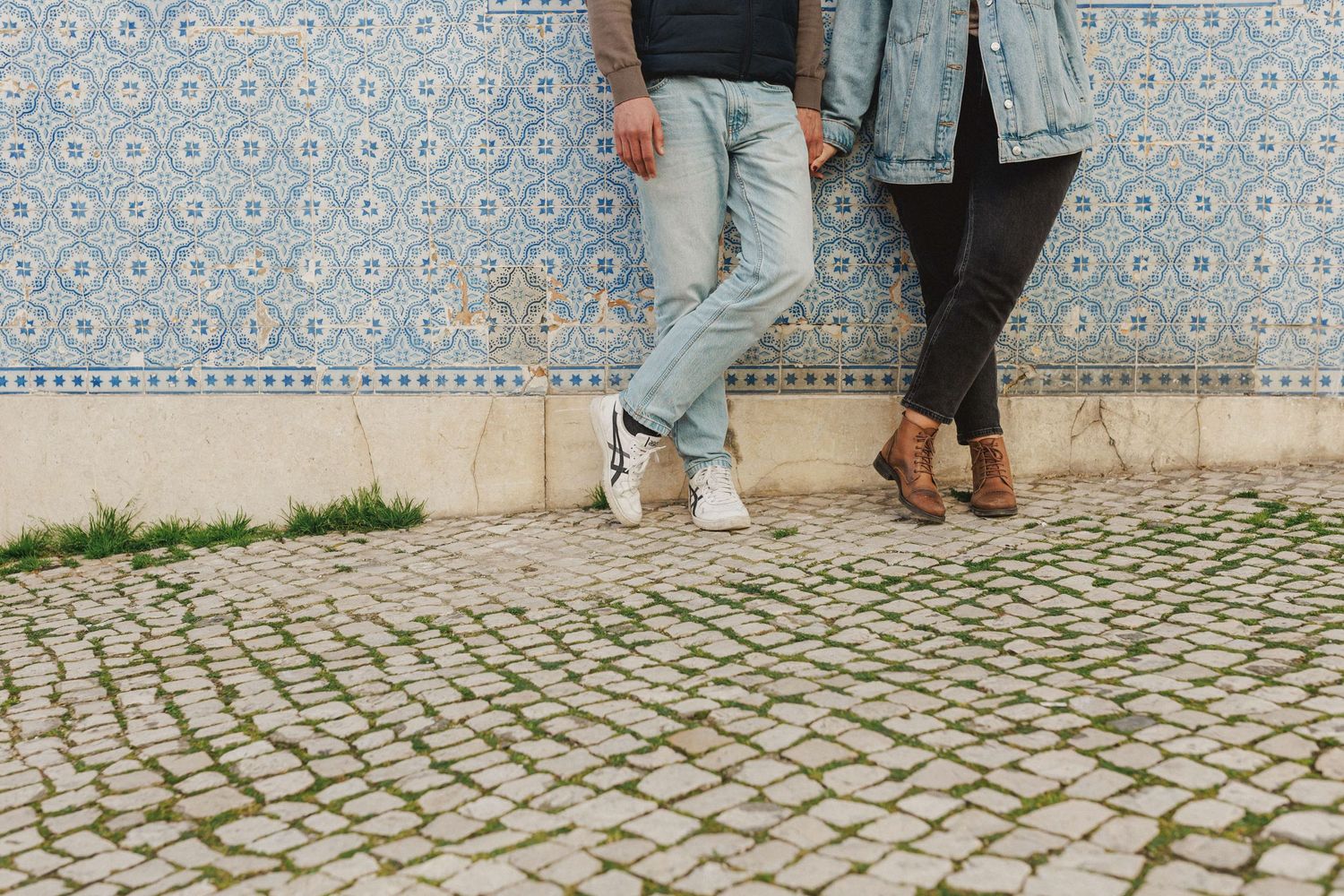 Detail of couple legs and cobblestone street in Baixa Lisbon during relaxed pre wedding session