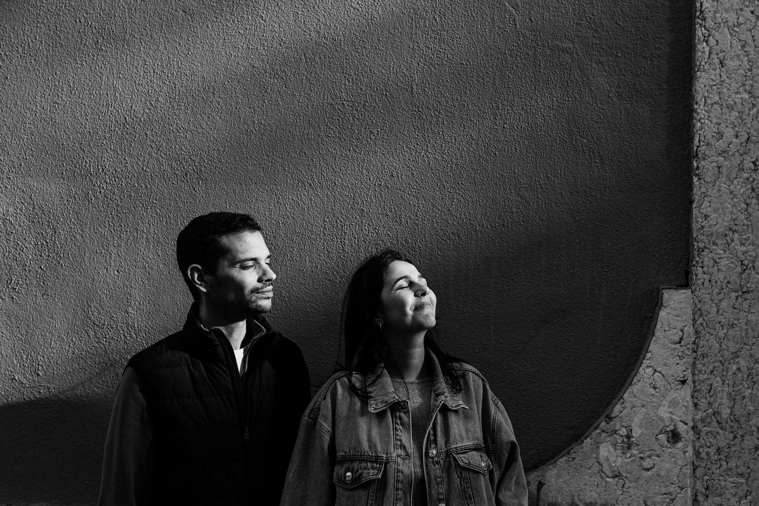 Black and white portrait of couple enjoying sunlight in Lisbon during romantic engagement shoot
