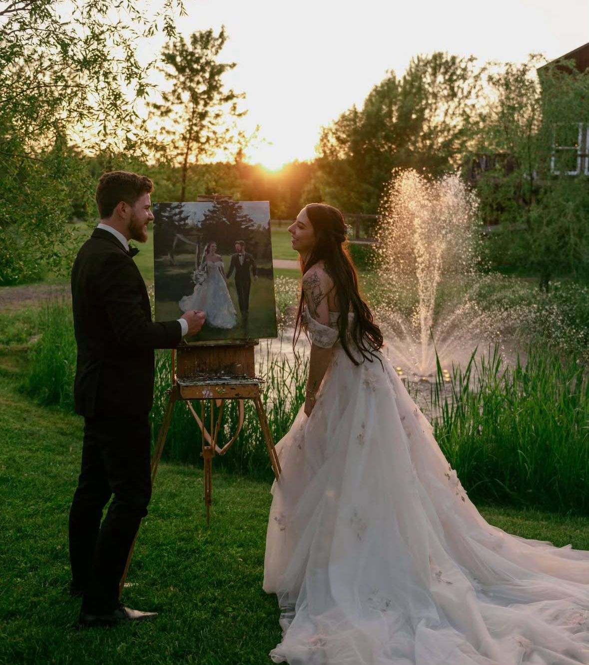 A couple shares an intimate moment at sunset in a garden setting with tall ornamental grasses and golden light.