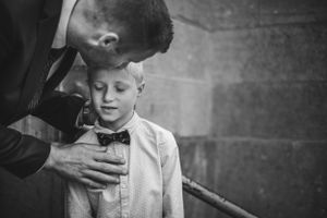 Intimate black and white moment captured in formal attire.