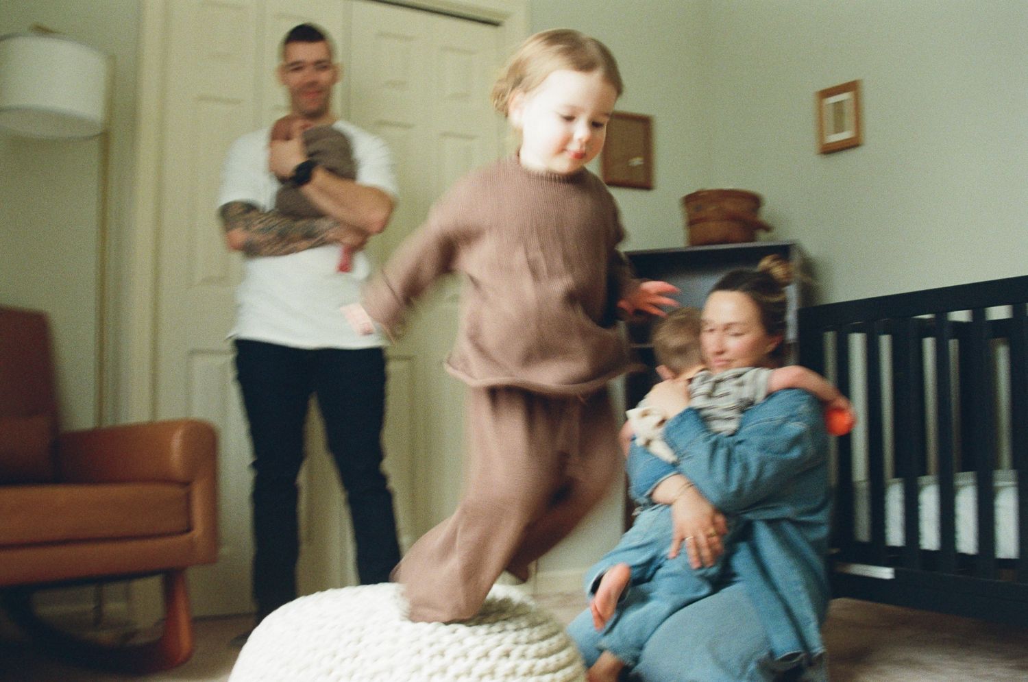 A sequence of blurry motion photos showing someone falling down wooden stairs in an interior setting.