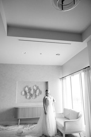 Security camera footage shows several angles of a modern minimalist white bedroom with clean lines and simple decor.