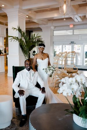 A four-panel collage shows someone in a white suit sitting in an elegant event space with palm plants and white decor.