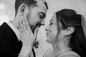 A romantic black and white photo series showing tender moments between a couple on their wedding day.