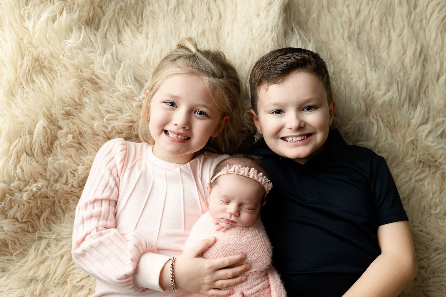 Big brother and sister holding newborn sister. Greenville, SC newborn photographer, Easley SC newborn photographer, Upstate SC newborn photo