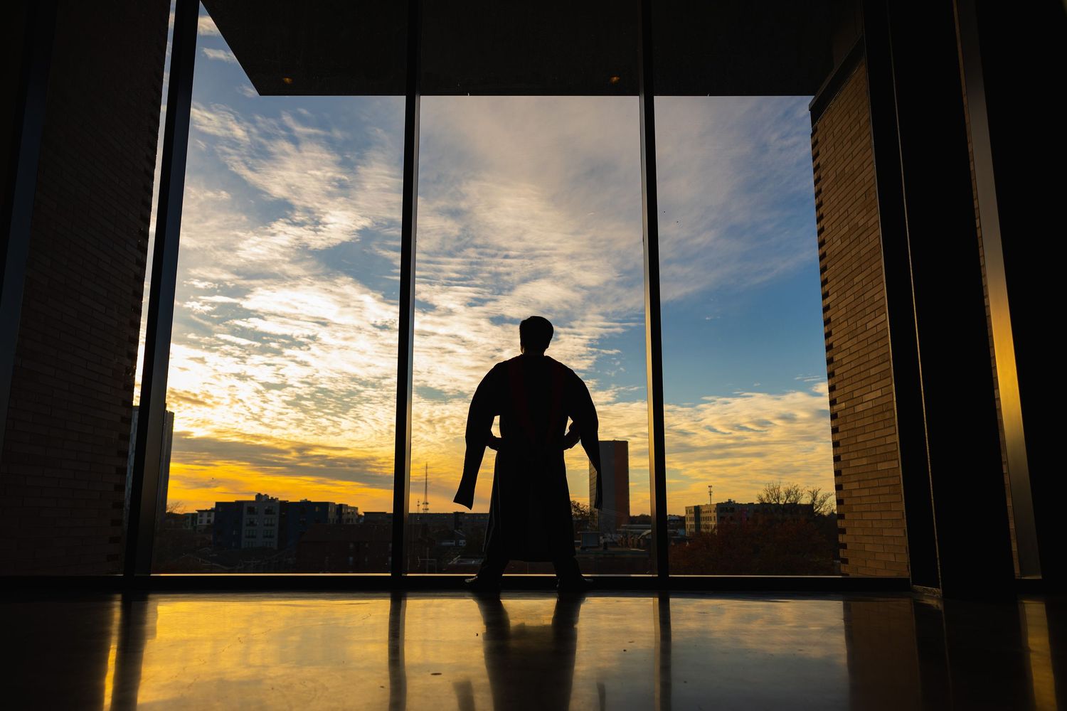 silhouette of a UIUC Master's graduating student at the CIF by the window
