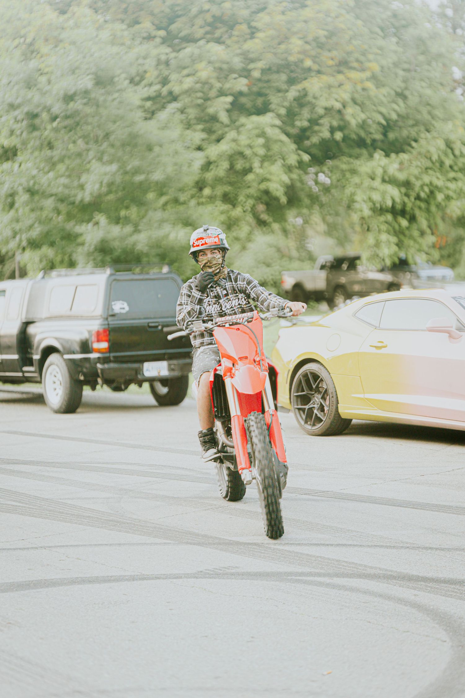 Action sequence showing skateboarding tricks performed on pavement with cars in background.