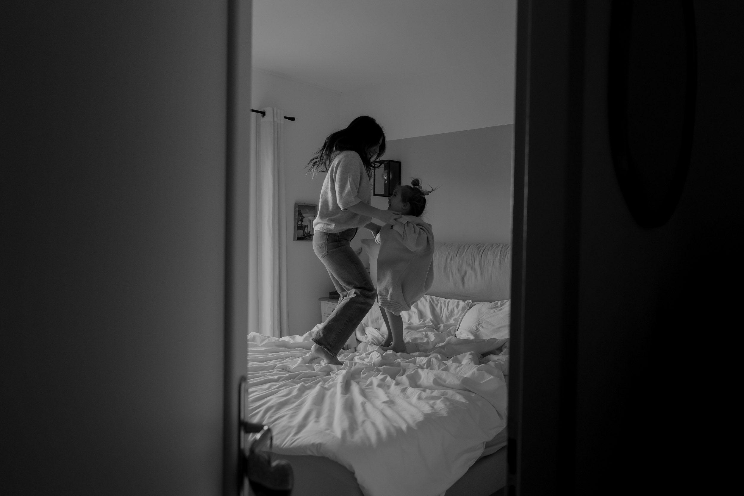 Silhouetted figures in a dimly lit bedroom creating a moody atmosphere.