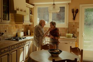 Warm-toned interior view of a rustic kitchen with wooden cabinets. shooting personne âgés pays basque grands parents